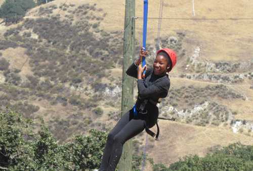 girl smiling on rope course